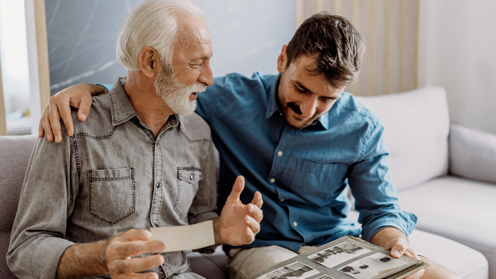 Father and son looking at photos